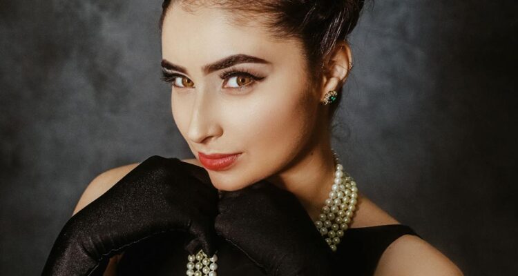 a young female looking at camera and wearing evening wear from past