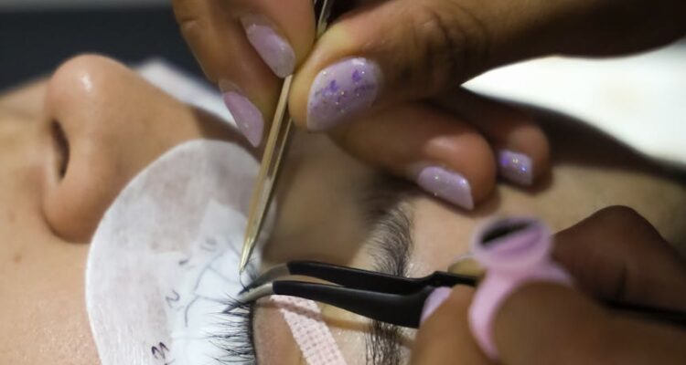 woman doing lashes at beautician