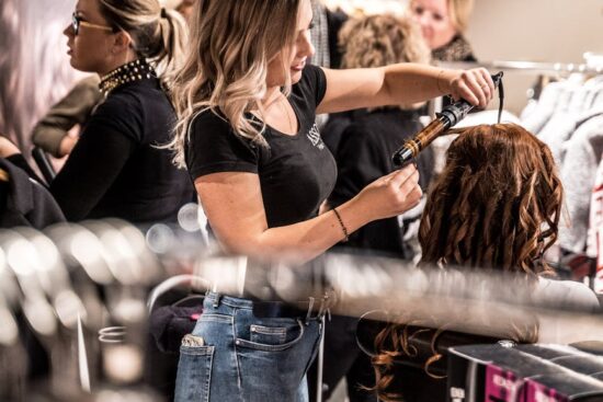woman curling another woman s hair