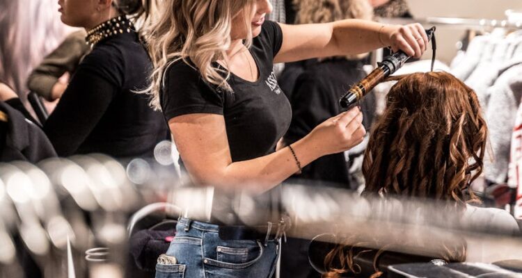 woman curling another woman s hair