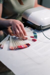 person holding artificial nail samples
