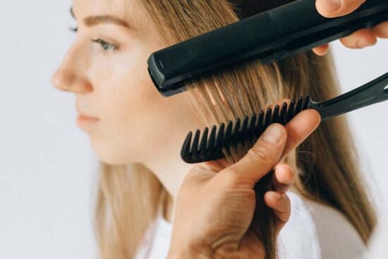 a person styling a woman s hair