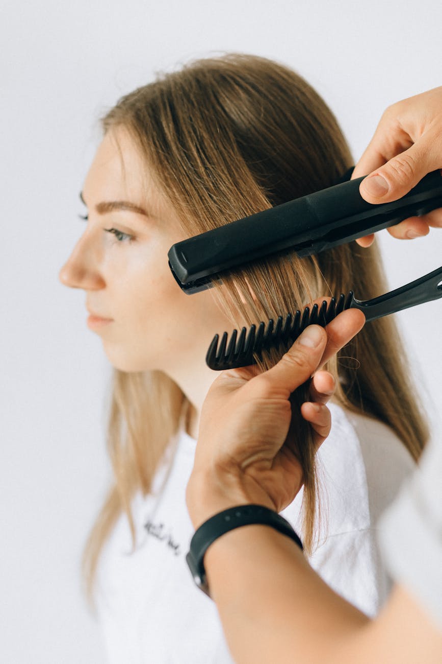 a person styling a woman s hair