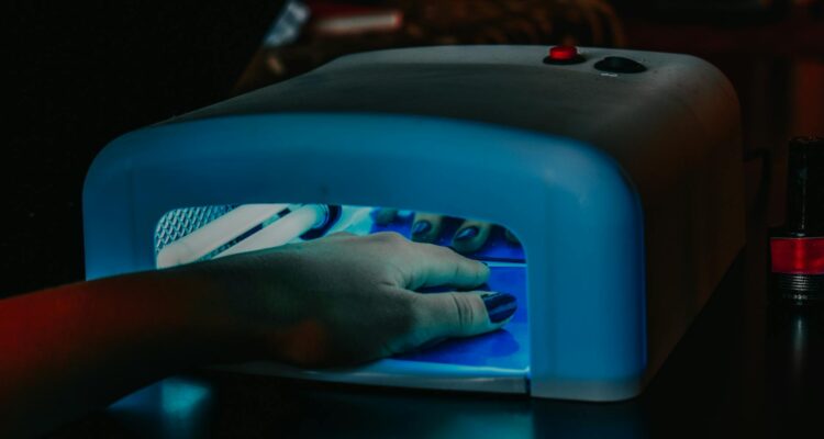 a person s hand inside the uv lamp